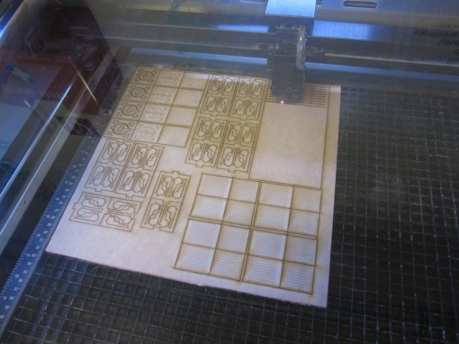 So here is the laser-cutter hard at work. As you can see I don't actually get that much out of a sheet because of the layers and complexity